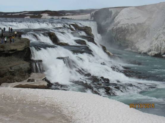Gullfoss with ice at the fringes. Note the people in upper left, for scale. In summer it has TWELVE TIMES the flow at this time.