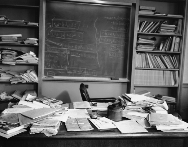 If you look up the word "Genius" in the dictionary, his photograph is there. This is the desk of someone that lives a tidy life of math and science in his mind, but likes his desk a mess.